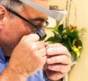 Jeweler examining a diamond ring for jewelry appraisal Portsmouth