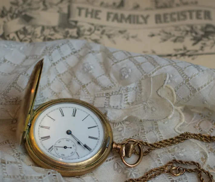 family heirloom gold pocket watch laying on top of a white handkerchief