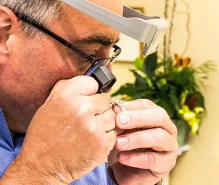 Jeweler examining a diamond ring for jewelry appraisal Portsmouth